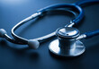 © radesign - Close up of a medical stethoscope on a dark blue background