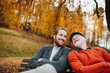 © Halfpoint - Grandad and grandson sitting on bench in park and talking.