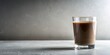 © parichart - A refreshing glass of chocolate beverage sits on a textured surface against a neutral backdrop