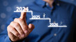 © Taohidul - Strategic Planning Concept Man Points to 2024, 2025, and 2026, Representing Plan, Action, Goals