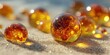 © Yauheniya - Amber Liquid Drops on Sandy Surface - Close-up of Nature’s Detail