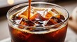 © Hilmi - Refreshing Iced Coffee A Close-Up View of Cold Brew with Ice Cubes