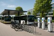 © Татьяна Евдокимова - Electric buses charging at an urban mobility hub promoting sustainable transportation with bicycle sharing and charging stations