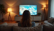 © MIJARI - Young woman relaxing on a cozy couch, watching a beautiful nature scene on TV in a warm, inviting living room.