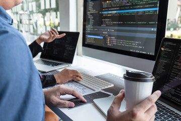 team of developer programmer working on project in software development computer in it company offic