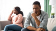 © Prostock-studio - Upset black couple young man and woman having relationships crisis, sitting on couch and looking aside, sad african american family thinking about divorce. Crisis in marriage concept