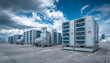 © john - Air conditioning units on modern building rooftop under cloudy blue sky. Industrial cooling systems feature ventilation, compressor technology, essential for climate control in urban, commercial