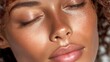 © BOJOShop - Close up of a young woman's face showing healthy glowing skin with eyes closed