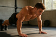 © Khan - Muscular Man Doing Push-Ups in a Gym
