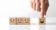 © Image Alchemy - Choosing positive attitude concept hand selecting happy face wooden block from sad neutral faces
