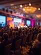 © Johannes - engaged attendees listening to speaker during corporate conference with blurred stage