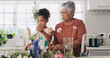 © peopleimages.com - Grandmother, child and flowers in kitchen for learning botany, help and bonding with family. Grandma, girl and plants in home for healthy growth, decoration or teaching floral care for hobby together