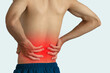 © Pcess609 - Close-up of a man holding his lower back with a red highlight showing pain, diseases and disorders of the spinal cord, back pain, lumbar pain, orthopedic surgery, chiropractic, and office syndrome.