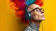 © Nataliia_Trushchenko - Man with a colorful mohawk and glasses is wearing headphones and appears to be listening to music