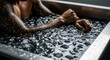 © Olesya - Man with tattoos in an ice bath, a recovery ritual for athletes and fitness enthusiasts. Post workout therapy.