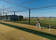 © Austockphoto - Cricket training and practice in the nets for left handed female cricket player