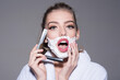 © Volodymyr - Young woman shave with razor. Woman shaving foam on face. Attractive girl is having a shave. Waxing, epilation, threading, shave and hair removal cream. Hair removal concept. Girl shave concept.