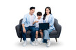 © STOCK88PHOTOGRAPHER - A family of three enjoys quality time looking at a laptop while sitting on a gray couch. The parents are both smiling and look happy as they are gathered with their child on PNG