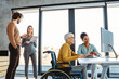 © NDABCREATIVITY - The image includes a person using a wheelchair, depicting inclusivity and teamwork in modern office