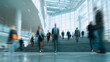 © Hachem - Blurred people are walking in a modern office building