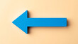 © hardvicore - Blue wooden arrow pointing left on beige backdrop. Return, backtracking, business concept.