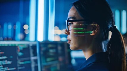 Asian Woman Coding on Computer Screens in Dark Room