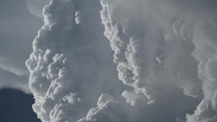 Wall Mural - Telephoto view of spectacular storm clouds billowing in a time lapse
