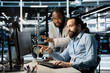 © DC Studio - Team of system administrators using computer in server farm, analyzing data. Data center office colleagues doing brainstorming, examining equipment, ensuring system integrity and security