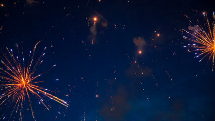 Fireworks exploding in the night sky during a celebration