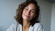 © Milos - This close-up image showcases a joyful woman with curly hair smiling at the camera, reflecting warmth and personality, embodying a sense of happiness in her modern lifestyle.