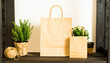 © PhoenixStudio - Eco-Friendly Shopping Display: Two eco-friendly paper bags, a small and a large, stand prominently amidst lush green plants, offering a natural, sustainable theme.