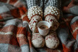 © john - Cozy woman in knitted winter warm socks and in pajamas holding a cup of hot cocoa during resting on checkered plaid blanket at home in winter time. Cozy time and winter drinks. Top view
