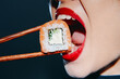 © VICHIZH - Close-up of a woman enjoying sushi with vibrant red lips and chopsticks, emphasizing the freshness and appeal of Japanese cuisine.