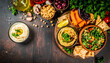© latifah - Fresh Mediterranean mezze platter with creamy hummus, tabbouleh, and roasted vegetables, perfect for sharing.