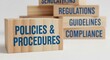 © zahidyounas - Policies and procedures regulations guidelines compliance for business standards and legal requirements on wooden blocks concept illustration