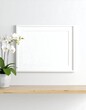 © Tumi - White framed picture on light wood shelf with white orchid