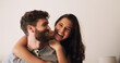 © peopleimages.com - Love, hug and couple with laughing in home for funny conversation, bonding together and security. Space, happy people and portrait in house with embrace, connection and support with relationship joke