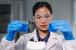 © Phimwilai - Scientist comparing two samples of blue liquid in laboratory