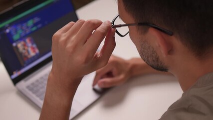 An Individual Deeply Focused on Working with a Laptop while Engaged in Programming Tasks AI and deep learning. Neural network model and diagram. Businessman using laptop computer to train AI.