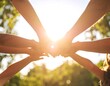 © ngati - Diverse Hands Unite in Golden Sunlight, Symbolizing Teamwork and Connection Outdoors.