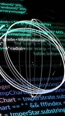 Wall Mural - animation of moving circles over computer language against black background