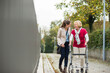 © TrueShot | Westend61 - Adult granddaughter assisting her grandmother walking with wheeled walker