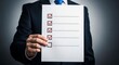 © J.G Studio - Man in suit holding a checklist with red check marks and empty box at bottom