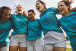 © TrueShot | Westend61 - Happy rugby players huddling under sky