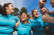 © TrueShot | Westend61 - Cheerful rugby players huddling under sky