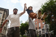 © TrueShot | Westend61 - Family and friends having fun outdoors in a city street