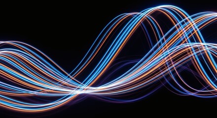 Canvas Print - flowing light trails of blue and orange against a black background