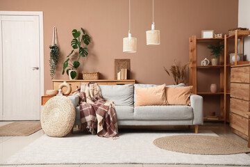Poster - comfortable sofa with plaid and pouf in interior of living room