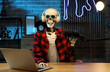 © Pixel-Shot - Human skeleton model with laptop at table in dark podcaster's studio