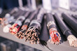 © Serg - Closeup of various electrical cable and wire types, showing different insulations and conductor materials, for construction and industrial use.